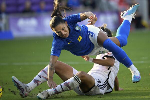 Brazil forward Debinha (9) is defended by Japan defender Moeka Minami, bottom, during the second half of a SheBelieves Cup women's soccer match, Thursday, Feb. 16, 2023, in Orlando, Fla. (AP Photo/Phelan M. Ebenhack)