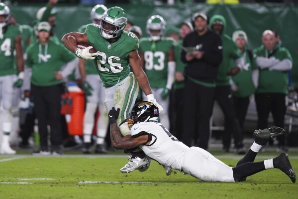 Eagles RB Saquon Barkley amazes with backward hurdle for first-down  reception | AP News