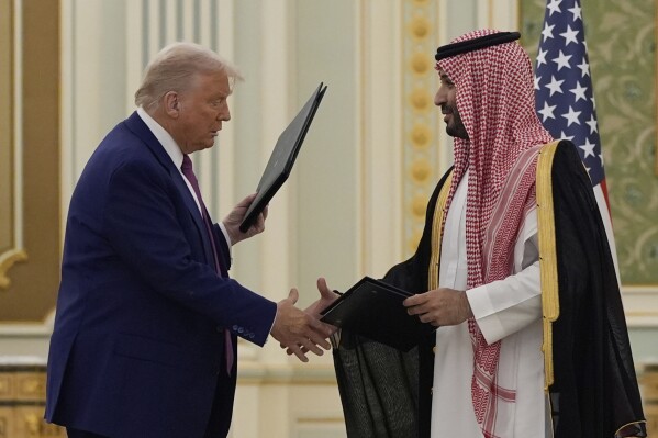 President Donald Trump and Saudi Crown Prince Mohammed bin Salman shake hands after exchanging documents during a signing ceremony at the Royal Palace in Riyadh, Saudi Arabia, Tuesday, May 13, 2025. (AP Photo/Alex Brandon)