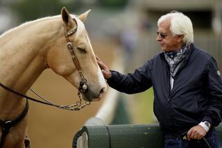 Trainer Bob Baffert pets an outrider's horse while watching workouts at Churchill Downs Wednesday, April 28, 2021, in Louisville, Ky. The 147th running of the Kentucky Derby is scheduled for Saturday, May 1. (AP Photo/Charlie Riedel)