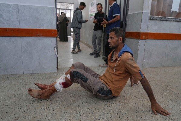 A Palestinian man, who was injured Tuesday night while trying to get access to humanitarian aid, waits to be treated at the al-Shifa Hospital, in Gaza City, Wednesday, June 11, 2025. (AP Photo/Jehad Alshrafi)