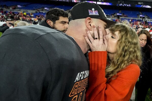 Taylor Swift kisses Kansas City Chiefs tight end Travis Kelce after an AFC Championship NFL football game against the Baltimore Ravens, Sunday, Jan. 28, 2024, in Baltimore. The Kansas City Chiefs won 17-10. (AP Photo/Julio Cortez)