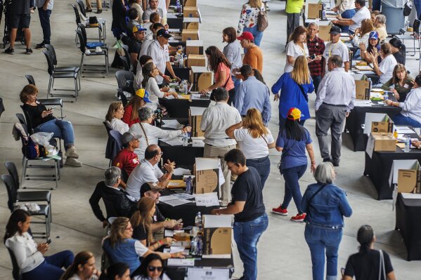 Thousands of exiled Venezuelans participated in the primaries elections to choose the opposition's candidate for next year's presidential election in Doral, Fla., on Sunday, Oct. 22, 2023. (Pedro Portal/Miami Herald via AP)