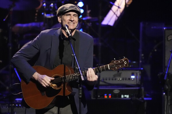 FILE - James Taylor performs at the 7th annual Love Rocks NYC concert in New York on March 9, 2023. Taylor kicks off his North American tour on May 29 at the Hollywood Bowl in Los Angeles. (Photo by Charles Sykes/Invision/AP, File)