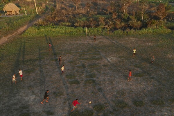 Indigenous people play soccer at the Wari' community in Guajara Mirim, Rondonia state, Brazil, Thursday, July 13, 2023. (AP Photo/Andre Penner)