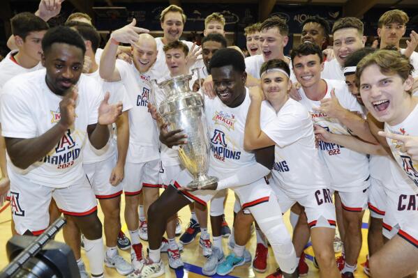 Arizona center Oumar Ballo (11), center, holds the winning trophy after Arizona defeated Creighton 81-79 in an NCAA college basketball game, Wednesday, Nov. 23, 2022, in Lahaina, Hawaii. (AP Photo/Marco Garcia)