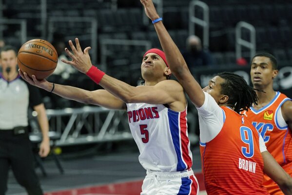Detroit Pistons guard Frank Jackson (5) attempts a layup as Oklahoma City Thunder center Moses Brown (9) defends during the second half of an NBA basketball game, Friday, April 16, 2021, in Detroit. (AP Photo/Carlos Osorio)