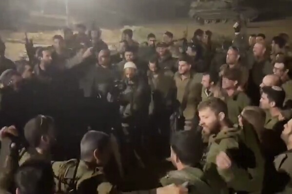 This image made from an undated video shared on X, formerly known as Twitter, shows Israeli Army troops with their arms slung around each other, chanting racist slogans as they dance in a circle, in Gaza. Several viral videos of Israeli soldiers behaving inappropriately in Gaza have emerged in recent days, creating a headache for the Israeli military as it faces an international outcry over its tactics and the rising civilian death toll in its war against Hamas. (X via AP)