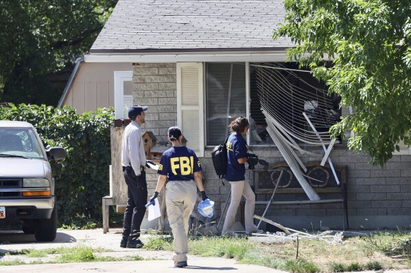 Law enforcement investigate the scene of a shooting involving the FBI Wednesday, Aug. 9, 2023 in Provo, Utah. A man accused of making threats against President Joe Biden was shot and killed by FBI agents hours before the president was expected to land in the state Wednesday, authorities said. (Laura Seitz/The Deseret News via AP)