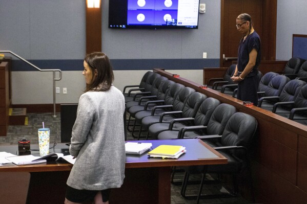 FILE - Clark County public defender Kristy Holston, left, and Nathan Chasing Horse stand during a court hearing Wednesday, April 5, 2023, in Las Vegas. The Nevada Supreme Court has denied Nathan Chasing Horse's request to toss a sprawling indictment that accuses the former “Dances With Wolves” actor of leading a cult, taking underage wives and sexually abusing Indigenous women and girls for decades. (AP Photo/Ty O'Neil, File)