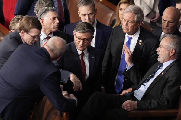 House Speaker Mike Johnson, R-La., speaks with Rep. Andy Harris, R-Md., right, and other members as the House of Representatives meets to elect a speaker and convene the new 119th Congress at the Capitol in Washington, Friday, Jan. 3, 2025. (AP Photo/Mark Schiefelbein)