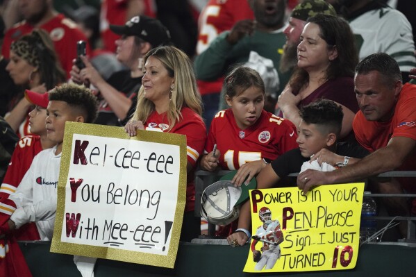 Fans hold signs during an NFL football game between the Kansas City Chiefs and the New York Jets, Sunday, Oct. 1, 2023 in East Rutherford, N.J. Eager as the National Football League has been to cater to the recent public fixation with Taylor Swift and Travis Kelce, it’s certainly not taking any credit for creating the "situationship" between the pop superstar and the Kansas City Chiefs tight end. (AP Photo/Vera Nieuwenhuis)