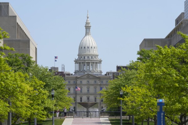 FILE - The Michigan State Capitol is photographed, Wednesday, May 24, 2023, in Lansing, Mich. Democrats in Michigan who have enjoyed control of the governor’s office and slim majorities in both chambers of the Legislature for the past year will soon temporarily lose their majority in the House of Representatives. Two state representatives, Lori Stone and Kevin Coleman, won mayoral races in suburban Detroit and are expected to vacate their seats later this month. The loss of two-seats will put the state House in a 54-54 deadlock until special elections can be held. (AP Photo/Carlos Osorio, File)