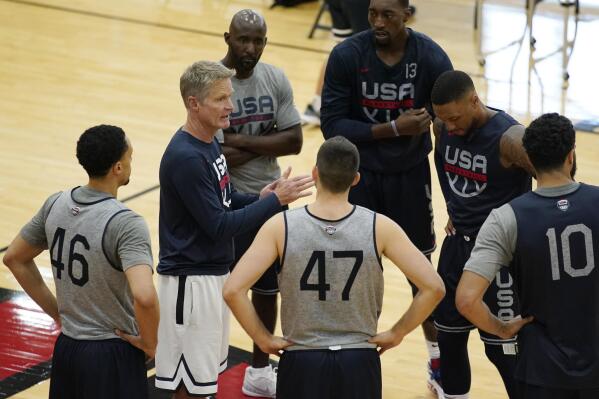 FILE - Assistant coach Steve Kerr, second from left, speaks with players during training for USA Basketball, Tuesday, July 6, 2021, in Las Vegas. USA Basketball is one year away from the start of the next men's Basketball World Cup, which serves as the primary qualifier for the 2024 Paris Olympics.(AP Photo/John Locher, File)