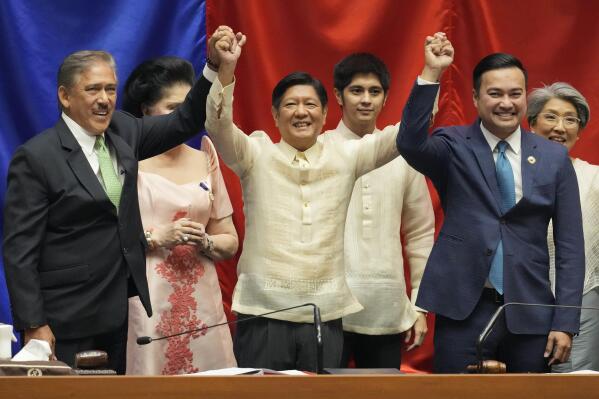 President-elect Ferdinand "Bongbong" Marcos Jr., center, raises hands with Senate President Vicente Sotto III, left, and House Speaker Lord Allan Velasco during his proclamation at the House of Representatives, Quezon City, Philippines on Wednesday, May 25, 2022. Marcos Jr. was proclaimed the next president of the Philippines by a joint session of Congress Wednesday in an astonishingly huge electoral triumph 36 years after his father was ousted as a brutal dictator by a pro-democracy uprising. (AP Photo/Aaron Favila)