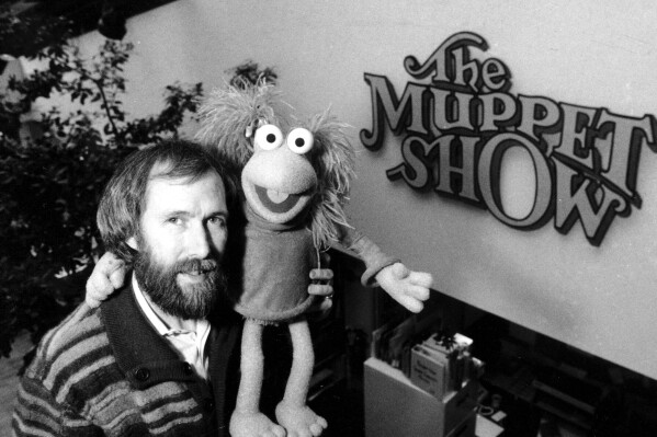 FILE - Muppet creator Jim Henson poses with one of his creations at Henson's 69th Street office in New York City on Feb. 6, 1984. Henson is the subject of the documentary "Jim Henson: Idea Man." (AP Photo/G. Paul Burnett, File)