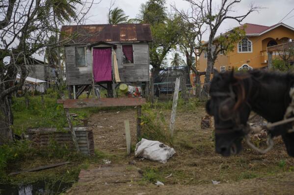 A wooden home stands on stilts in Ann's Grove, one of Guyana’s poorest communities, Saturday, April 15, 2023. The nation's oil boom will generate billions of dollars for this largely impoverished nation. (AP Photo/Matias Delacroix)