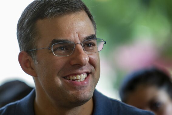 FILE - In this Aug. 21, 2019, file photo Rep. Justin Amash, I-Cascade Township, holds a constituent meeting at Rising Grinds Cafe, in Grand Rapids, Mich. Amash, a Trump critic, said Saturday, May 16, 2020, that he has decided not to seek the Libertarian nomination to run for president. (Cory Morse/The Grand Rapids Press via AP, File)