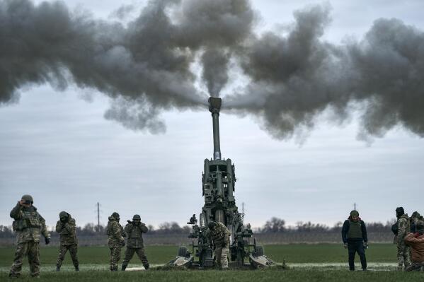 FILE - Ukrainian soldiers fire at Russian positions from a U.S.-supplied M777 howitzer in Ukraine’s Kherson region on Jan. 9, 2023. Ukraine’s Western allies have promised new supplies of weapons, including hundreds of battle tanks and other armored vehicles, along with artillery, rockets and other equipment. (AP Photo/Libkos, File)