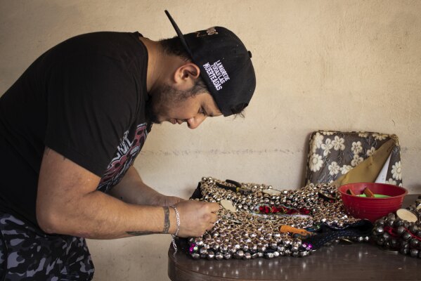 Daniel Davila prepares his costume at home in San Agustin, Mexico, Monday, Oct. 30, 2023. Mexicans in the Oaxacan town celebrate the traditional Muerteada, a theatrical recreation that is performed through the night of November 1 until the early morning of the following day, with dances and music parading through the streets, while telling the story of how a deceased person is resurrected with the help of a priest, a doctor and a spiritist. (AP Photo/Maria Alferez)