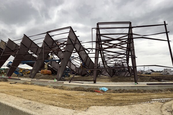 Twisted girders and debris cover the ground from a deadly structure collapse at a construction site near the Boise Airport on Thursday, Feb. 1, 2024 in Boise, Idaho. Authorities responded Wednesday to the privately owned steel-framed hangar, which suffered a “catastrophic” collapse, Boise Fire Department Operations Chief Aaron Hummel said during an earlier news briefing. (Darin Oswald /Idaho Statesman via AP)