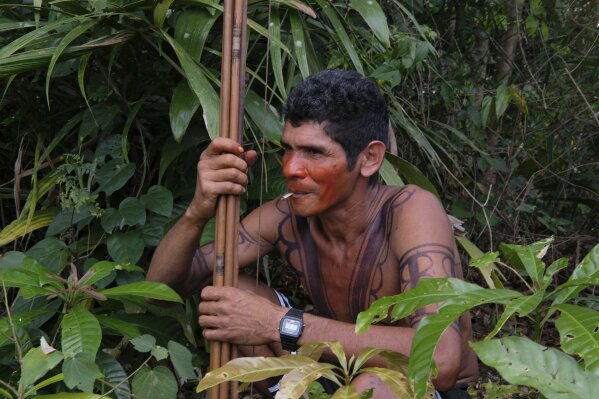 Luiz Tembe, an indigenous Tembe warrior, smokes a cigarette as he waits for police to arrive with other members of his tribe on the Alto Rio Guama indigenous reserve in Para state, Brazil, Wednesday, Sept. 4, 2019. Their Alto Rio Guama homeland is officially protected. But in reality, it’s under siege by loggers who try to extract prized hardwood in a Brazilian state that is one of the Amazon’s largest producers and exporters of timber. (AP Photo/Luis Andres Henao)