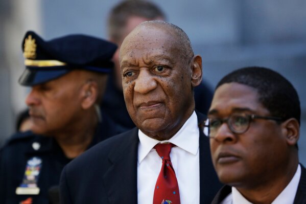 
              Bill Cosby, center, leaves the the Montgomery County Courthouse after being convicted of drugging and molesting a woman, Thursday, April 26, 2018, in Norristown, Pa.  (AP Photo/Matt Slocum)
            