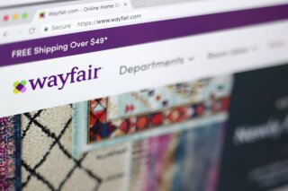 FILE - This April 17, 2018, file photo shows the Wayfair website on a computer in New York. Self-proclaimed internet sleuths are matching up names of Wayfair's products to those of missing children as part of a baseless conspiracy theory that claims the retail giant is using storage cabinets to traffic children. Wayfair responded: “There is, of course, no truth to these claims.” (AP Photo/Jenny Kane, File)