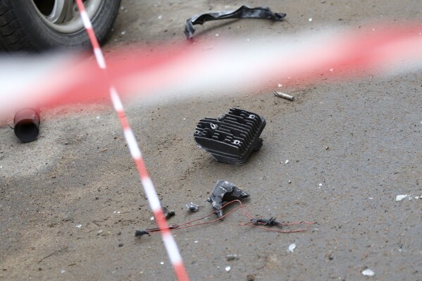 Scattered remains lie on the ground near a damaged apartment's building after a reported drone attack in St. Petersburg, Russia, Saturday, March 2, 2024. (AP Photo)