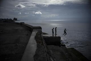 Boys spend the afternoon jumping into the water from the sea wall or the Malecon in Havana, Cuba, Thursday, Sept. 15, 2022. (AP Photo/Ramon Espinosa)