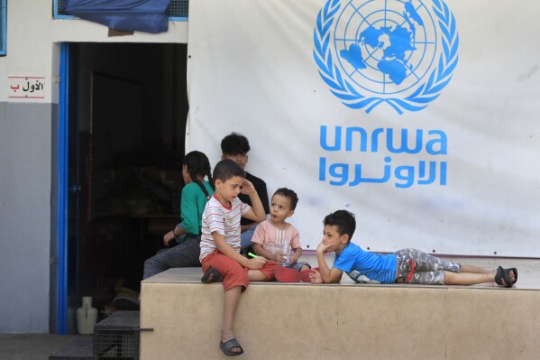 Palestinian children who fled with their parents from their houses in the Palestinian refugee camp of Ein el-Hilweh, gather in the backyard of an UNRWA school, in Sidon, Lebanon, Sept. 12, 2023. (AP Photo/Mohammed Zaatari, File)
