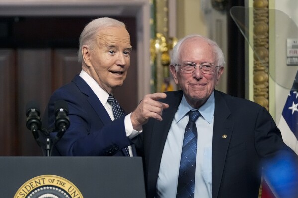 FILE - President Joe Biden stands with Sen. Bernie Sanders, I-Vt., after he spoke about reducing health care costs in the Indian Treaty Room in the Eisenhower Executive Office Building on the White House complex in Washington, Wednesday, April 3, 2024. (AP Photo/Mark Schiffelbein )
