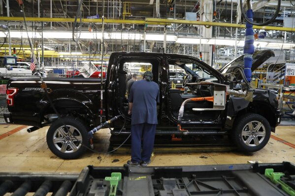 FILE - In this Sept. 27, 2018, file photo a United Auto Workers assemblyman installs seating in a 2018 Ford F-150 truck being assembled at the Ford Rouge assembly plant in Dearborn, Mich. Ford Motor Co. said Tuesday, Dec. 17, 2019, that it is adding 3,000 jobs at two factories in the Detroit area and investing $1.45 billion to build new pickup trucks, SUVs, and electric and autonomous vehicles. At the Dearborn truck plant $700 million will be invested. (AP Photo/Carlos Osorio, File)