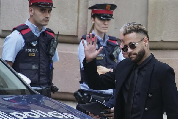 FILE - Former FC Barcelona player Neymar who now plays for Paris Saint-Germain waves on arrival at a court in Barcelona, Spain, Monday Oct. 17, 2022. On Tuesday, Dec. 13, 2022, a Spanish court has acquitted soccer star Neymar and his fellow defendants in a fraud and corruption trial related to the Brazilian’s 2013 transfer from Santos to Barcelona. The court says in a statement that “it has not been proven that there was a false contract or that DIS was intended to be harmed." (AP Photo/Joan Mateu Parra, File)