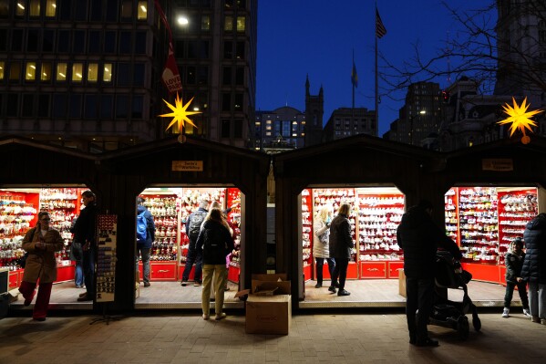 FILE - Shoppers visit the Christmas Village in Philadelphia, Dec. 13, 2023. On Wednesday, the Commerce Department releases U.S. retail sales data for December. (AP Photo/Matt Rourke, File)