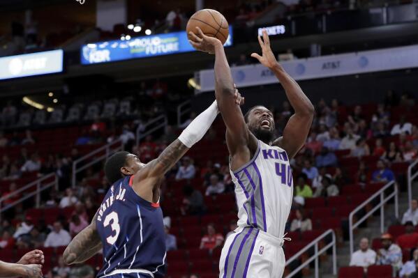 Sacramento Kings forward Harrison Barnes (40) is fouled on his shot attempt by Houston Rockets guard Kevin Porter Jr. (3) during the first half of an NBA basketball game Friday, April 1, 2022, in Houston. (AP Photo/Michael Wyke)