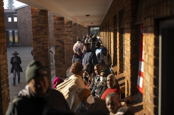 Voters line up to cast their ballot Wednesday May 29, 2024 in general elections in Soweto, South Africa. South Africans began voting Wednesday at schools, community centers and in large white tents set up in open fields in an election seen as their country’s most important in 30 years. It could put their young democracy in unknown territory. (AP Photo/Jerome Delay)
