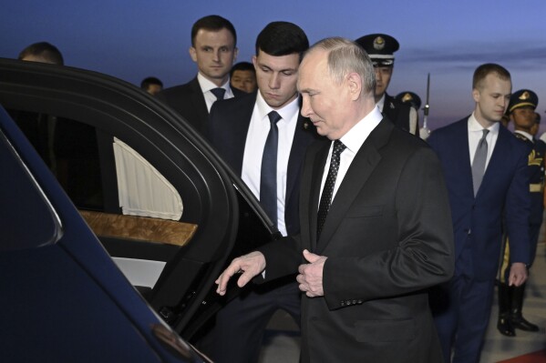 In this photo released by Xinhua News Agency, Russia's President Vladimir Putin, foreground, gets into a vehicle upon arrival at the Beijing Capital International Airport in Beijing, Thursday, May 16, 2024. Putin arrived Thursday in Beijing for a two-day state visit to China, in a show of unity between the authoritarian allies as Moscow presses forward with a new offensive in Ukraine. (Yue Yuewei/Xinhua via AP)
