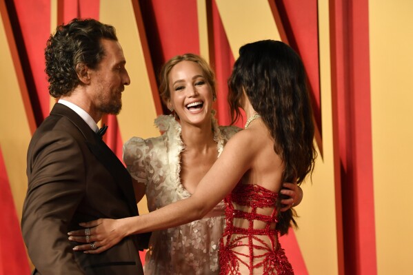 Matthew McConaughey, from left, Jennifer Lawrence, and Camila Alves arrive at the Vanity Fair Oscar Party on Sunday, March 10, 2024, at the Wallis Annenberg Center for the Performing Arts in Beverly Hills, Calif. (Photo by Evan Agostini/Invision/AP)