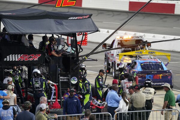 The car of Ricky Stenhouse Jr. is towed away from the pit of Kyle Busch during the NASCAR All-Star auto race at North Wilkesboro Speedway in North Wilkesboro, N.C., Sunday, May 19, 2024. Stenhouse crashed after contact with Busch and stopped his damaged car at Busch's team's pit. (AP Photo/Chuck Burton)