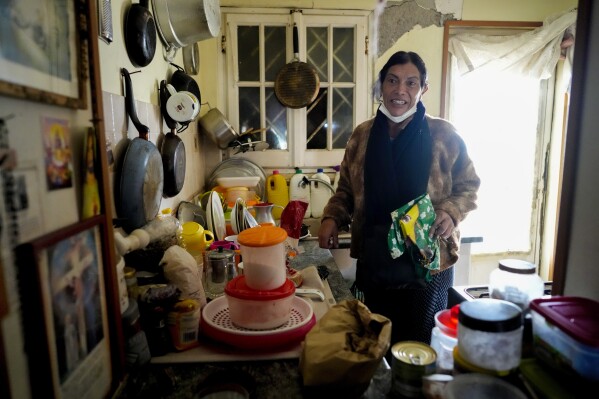 Andrea Paola Torres Lopez, a transgender woman from Colombia also known as Consuelo, stands in the kitchen of her house in Torvaianica, Italy, Thursday, Nov. 16, 2023. Pope Francis’ recent gesture of welcome for transgender Catholics has resonated strongly in this working class, seaside town south of Rome, where a community of trans women has found help and hope through a remarkable friendship with the pontiff forged during the darkest times of the pandemic. (AP Photo/Andrew Medichini)