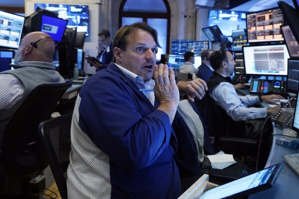 FILE - Trader Michael Milano, center, works with colleagues on the floor of the New York Stock Exchange on May 30, 2024. World stocks are mixed on Friday, June 7, 2024, after a steady day on Wall Street as markets anticipate key U.S. jobs data to be revealed later in the day. (AP Photo/Richard Drew, File)