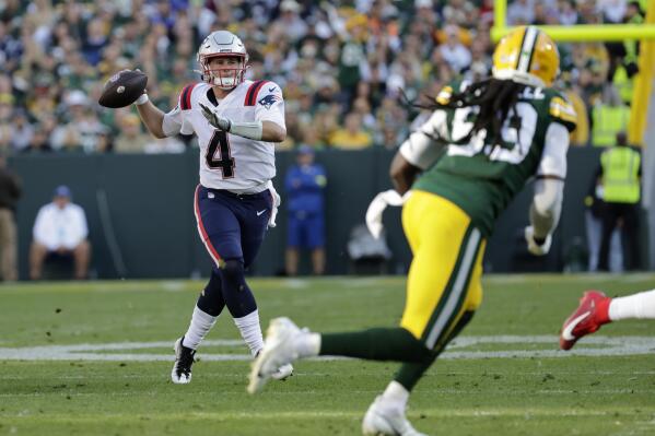 New England Patriots quarterback Bailey Zappe (4) throws a pass during the first half of an NFL football game against the Green Bay Packers, Sunday, Oct. 2, 2022, in Green Bay, Wis. (AP Photo/Mike Roemer)