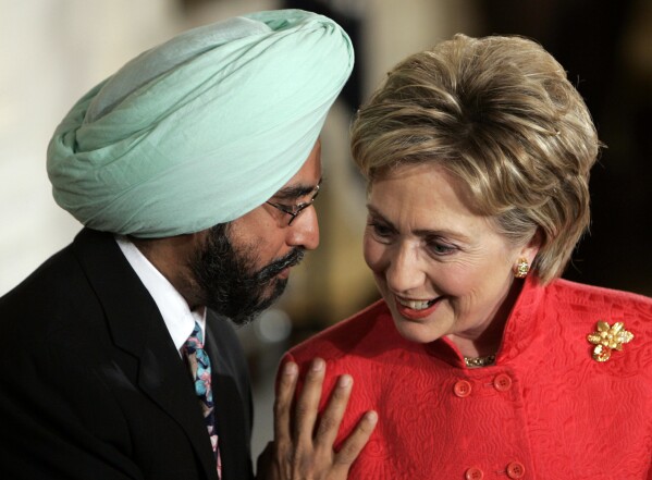 FILE - Democratic presidential hopeful Sen. Hillary Clinton, D-N.Y., right, talks with Dr. Rajwant Singh, Chairman of the Sikh Council on Religion, left, during the National Day of Prayer ceremony in the East Room, of the White House in Washington, May 3, 2007. (AP Photo/Ron Edmonds, File)