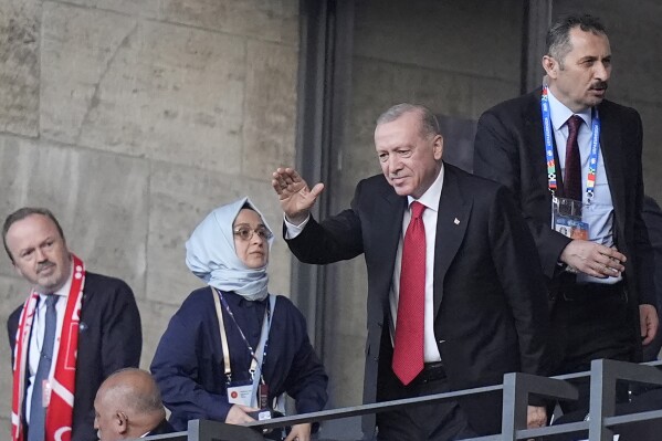 The President of Turkey Recep Erdogan waves to the crowd ahead of the start of the quarterfinal match between the Netherlands and Turkey at the Euro 2024 soccer tournament in Berlin, Germany, Saturday, July 6, 2024. (AP Photo/Matthias Schrader)