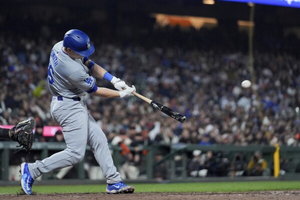 Los Angeles Dodgers' Will Smith hits a two-run double against the San Francisco Giants during the 10th inning of a baseball game Monday, May 13, 2024, in San Francisco. (AP Photo/Godofredo A. Vásquez)