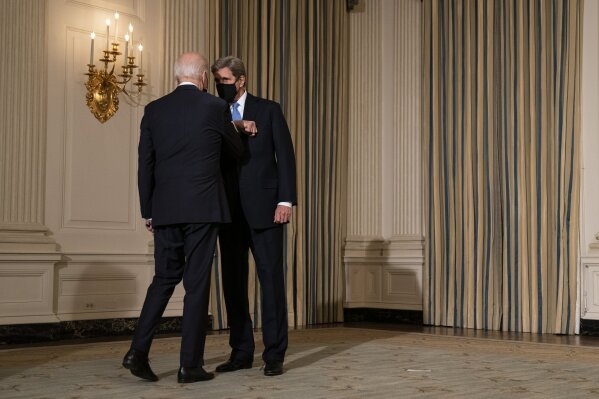 President Joe Biden greets Special Presidential Envoy for Climate John Kerry as he arrives to deliver remarks on climate change and green jobs, in the State Dining Room of the White House, Wednesday, Jan. 27, 2021, in Washington. (AP Photo/Evan Vucci)