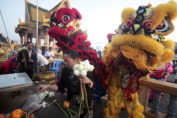 Members of Cambodian Chinese community perform lion dance on Friday morning, Feb. 9, 2024, in front of Royal Palace in Phnom Penh, Cambodia, ahead of Lunar New Year. (APPhoto/Heng Sinith)