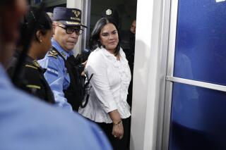 FILE - Former Honduran first lady Rosa Elena Bonilla de Lobo leaves court after her conviction on corruption charges in Tegucigalpa, Honduras, Aug. 20, 2019. A judge sentenced Bonilla de Lobo to 14 years in prison Wednesday, Sept. 21, 2022, on corruption charges, the second time Bonilla had been sentenced. (AP Photo/Elmer Martinez, File)
