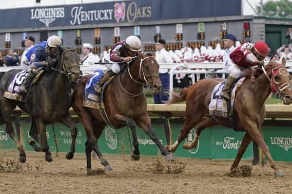 Rich Strike (21), with Sonny Leon aboard, leads Epicenter (3), with Joel Rosario aboard, and Zandon (10), with Flavien Prat aboard, down the straightaway to win the 148th running of the Kentucky Derby horse race at Churchill Downs Saturday, May 7, 2022, in Louisville, Ky. (AP Photo/Mark Humphrey)